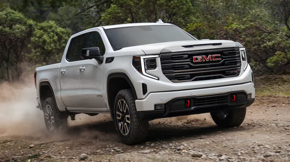 White 2023 GMC sierra 1500 front/side view driving on dirt path