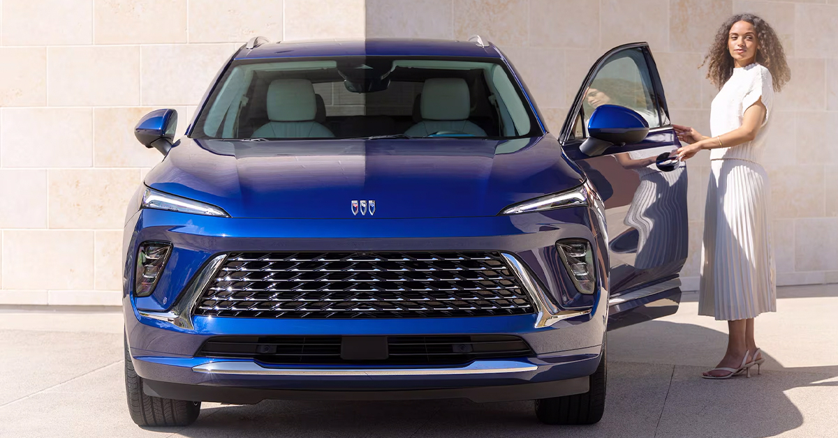 2025 Buick Envision front view with a woman opening the driver's side